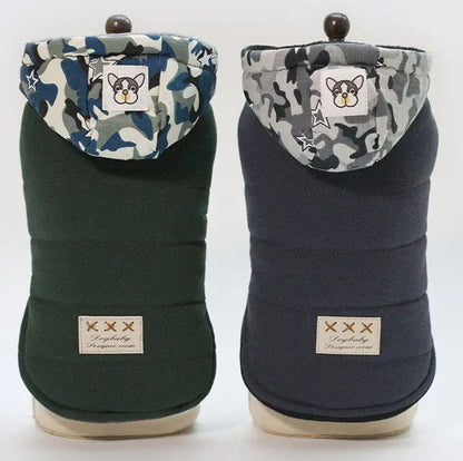 Two dog coats with camouflage hoods on a white background